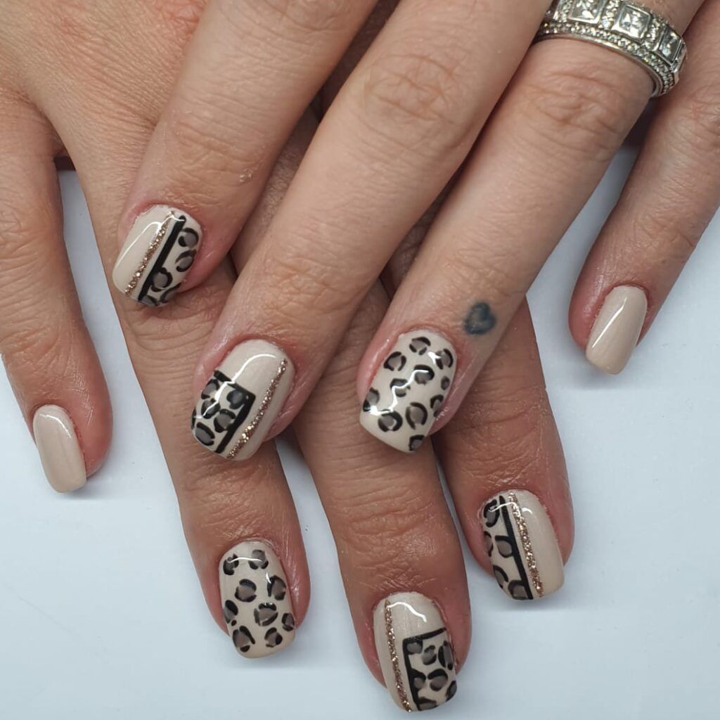 Detailed neutral and animal-print nail art